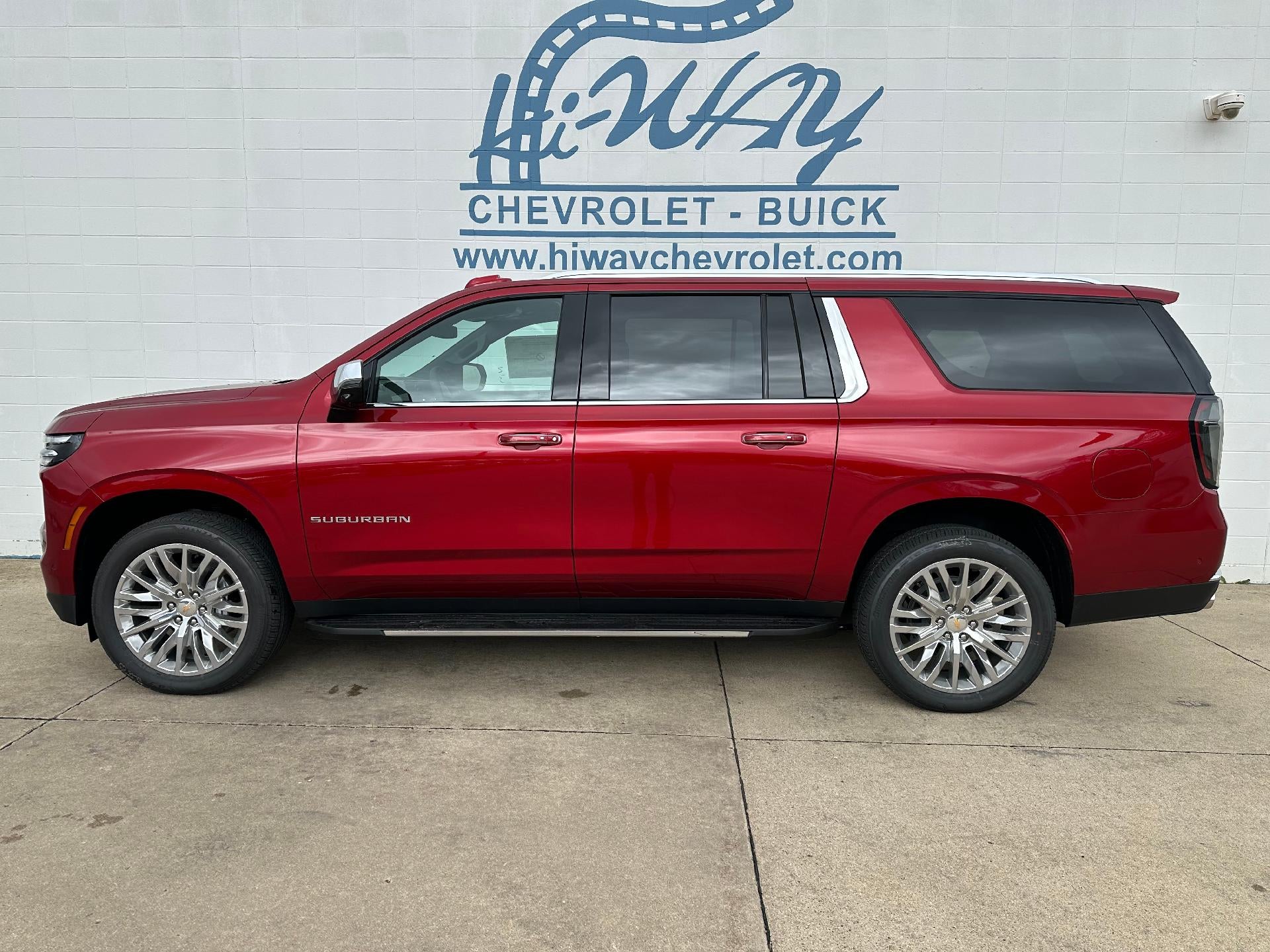 2026 Chevrolet Suburban Premier in Radiant Red Tintcoat — front three-quarter view