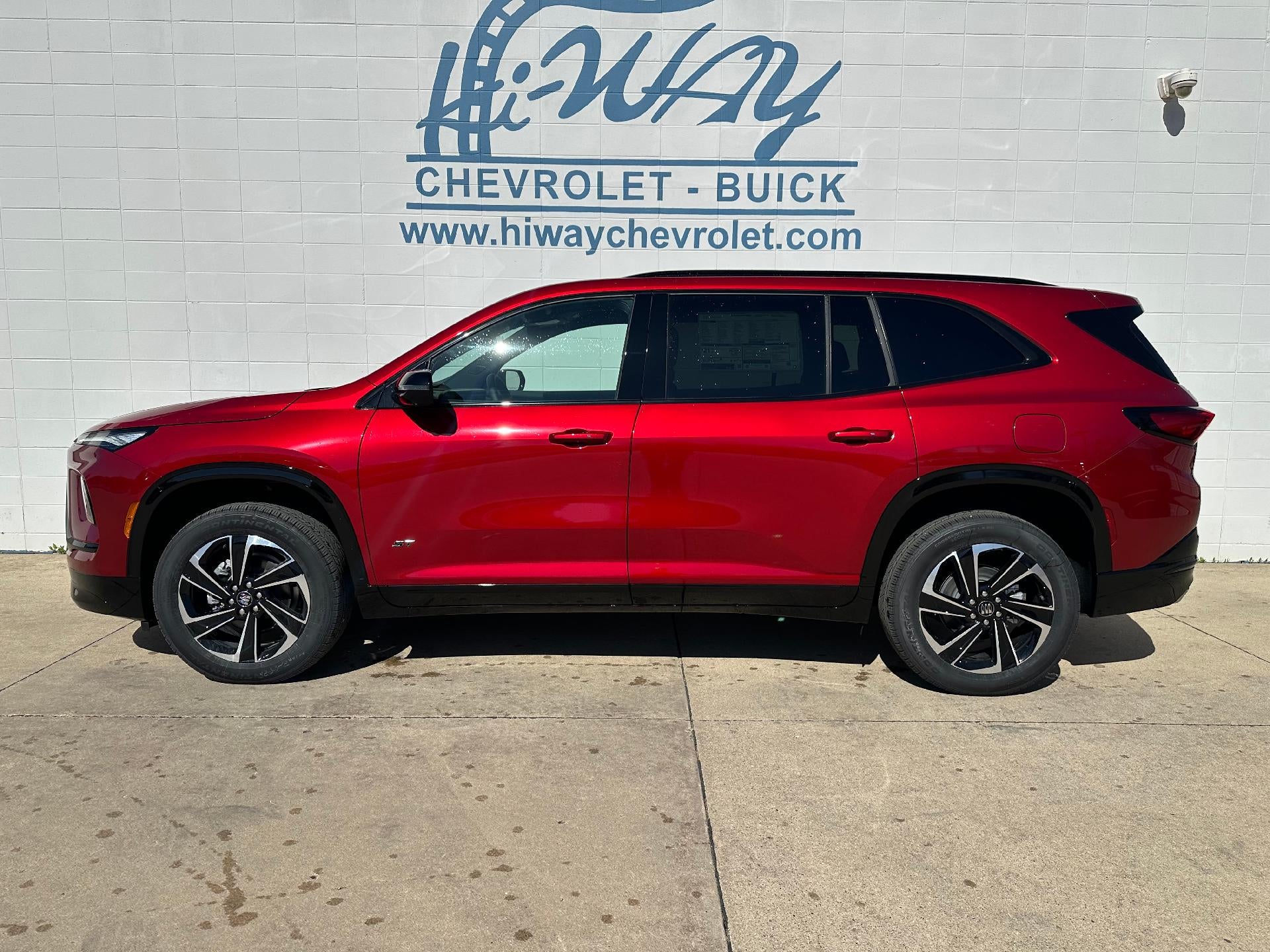 2026 Buick Enclave Sport Touring in Cherry Red Tintcoat — front three-quarter view