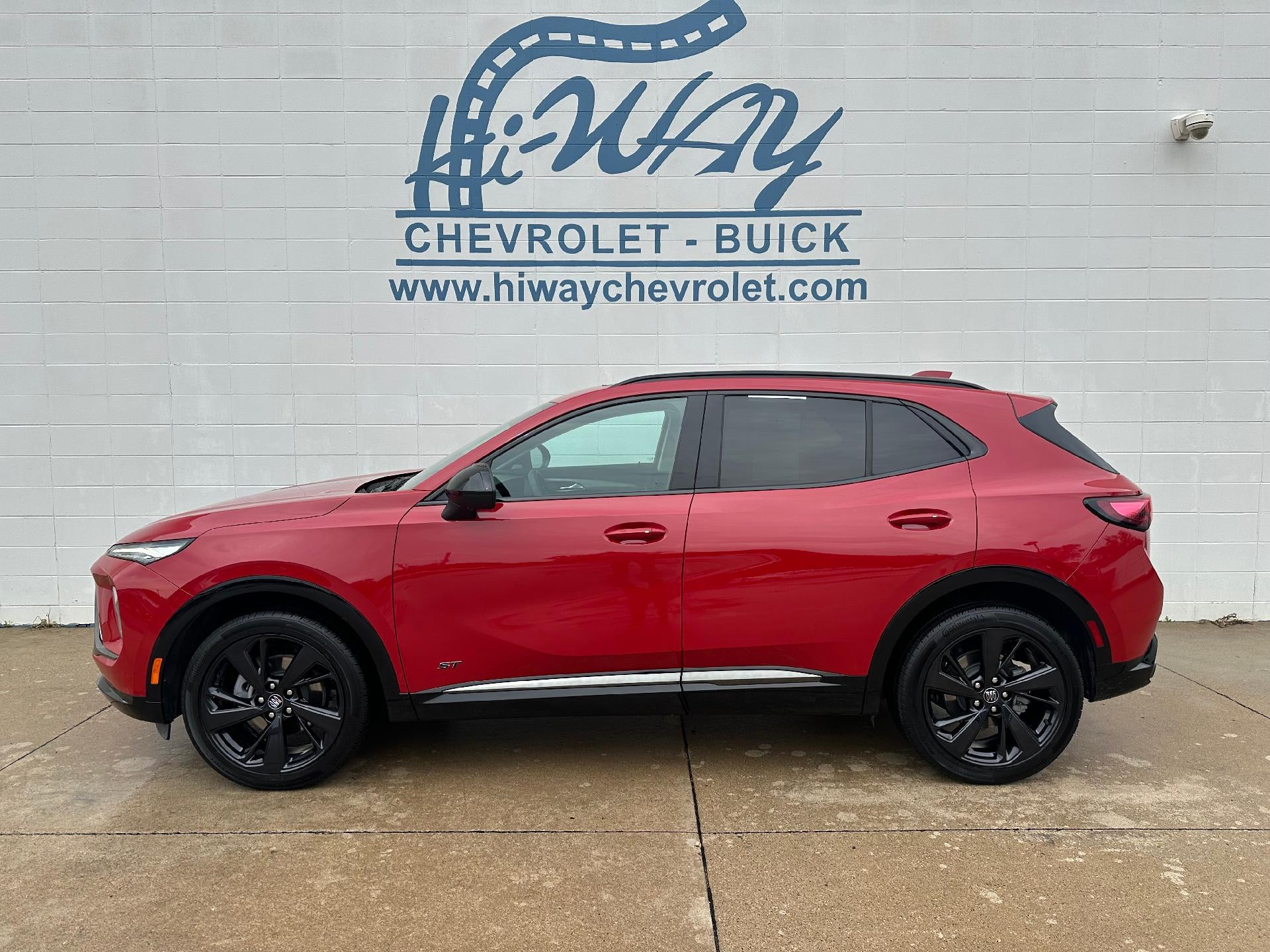 2025 Buick Envision Sport Touring in Brilliant Red — front three-quarter view